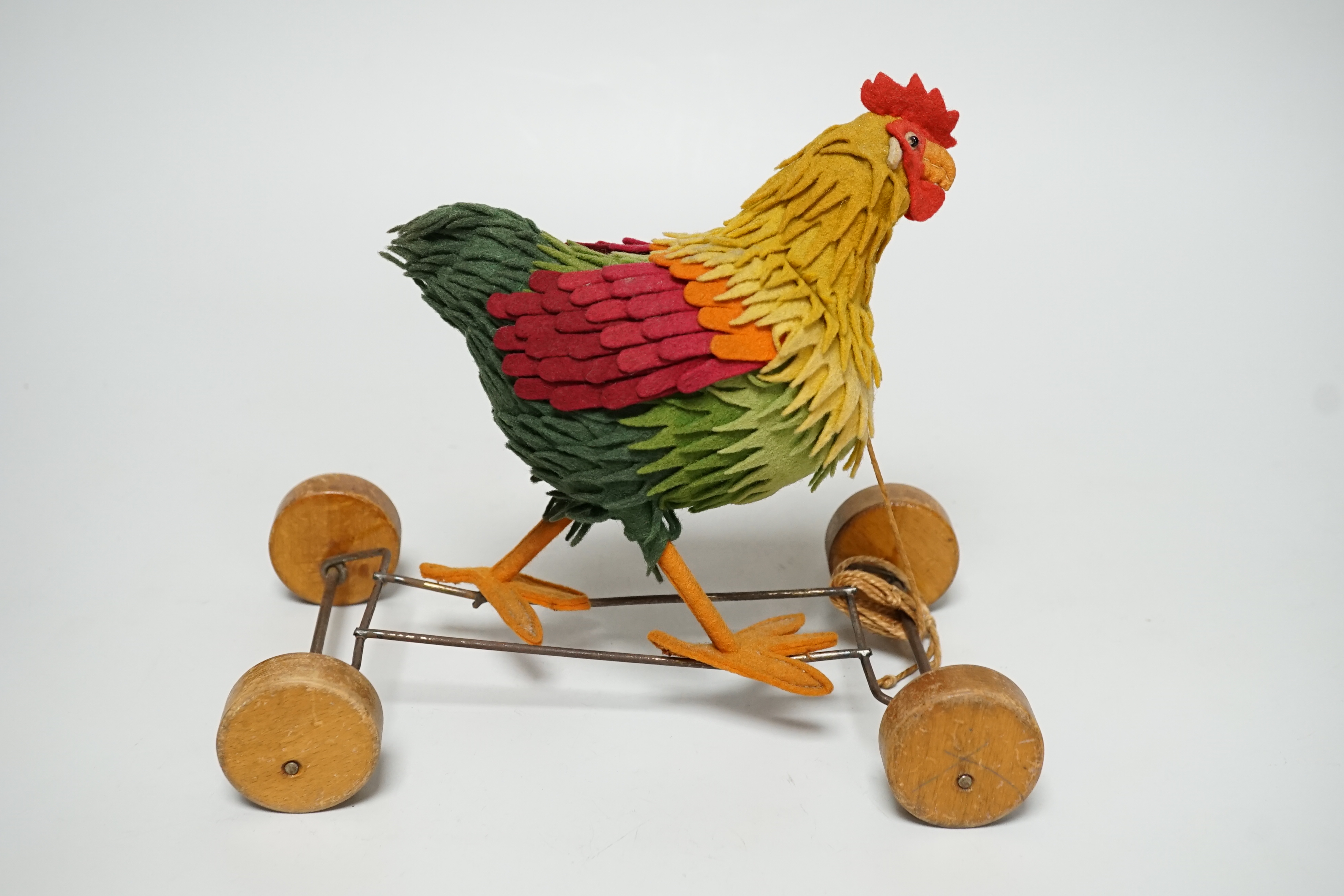 A Steiff cockerel on wooden wheel, c.1915, no button, good condition